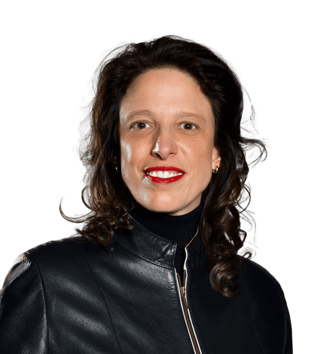 Professional headshot of a woman with dark, wavy hair, wearing a black leather jacket and red lipstick, smiling at the camera.